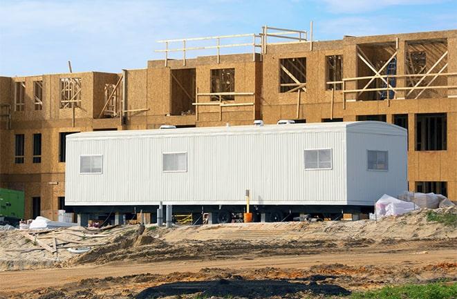 crane lifting modular building for construction office rentals in West Hills